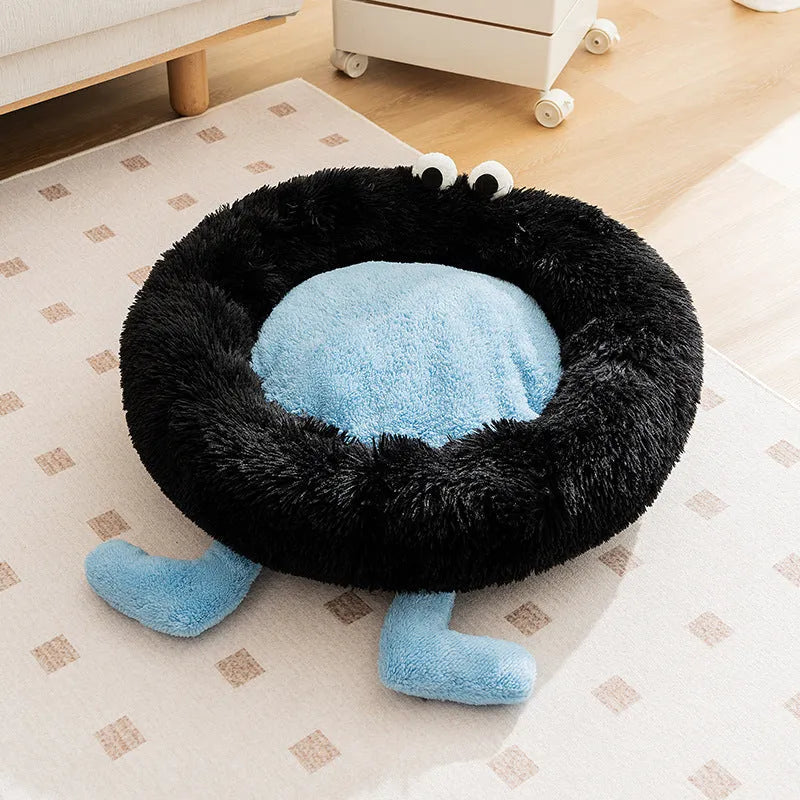 Blue plush kennel bed for dogs or cats with raised sides, shown in a home setting.