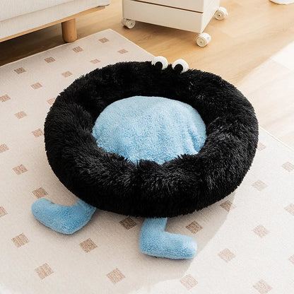 Blue plush kennel bed for dogs or cats with raised sides, shown in a home setting.