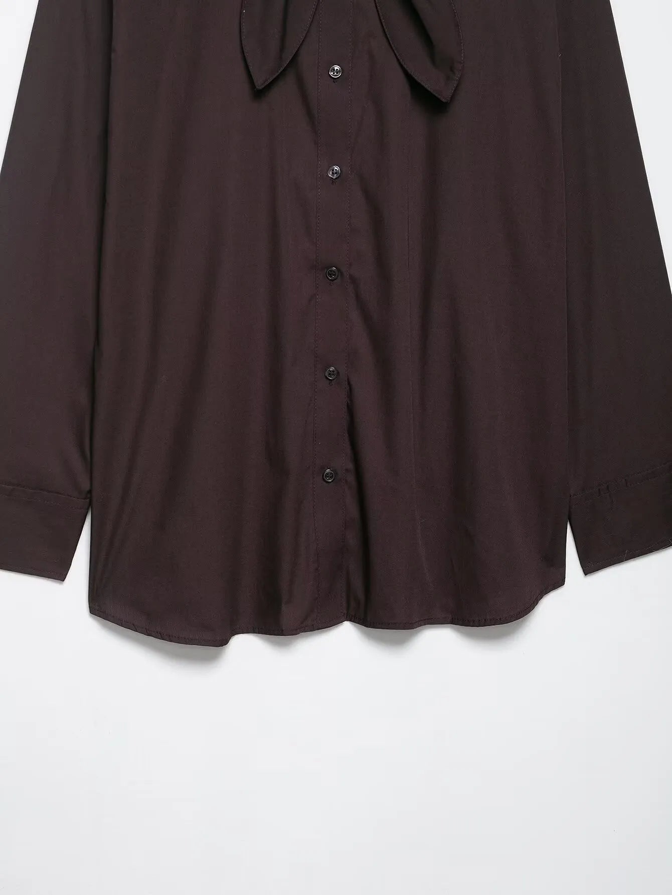 Brown women's loose-fit poplin shirt with long sleeves and an attached bow tie scarf.