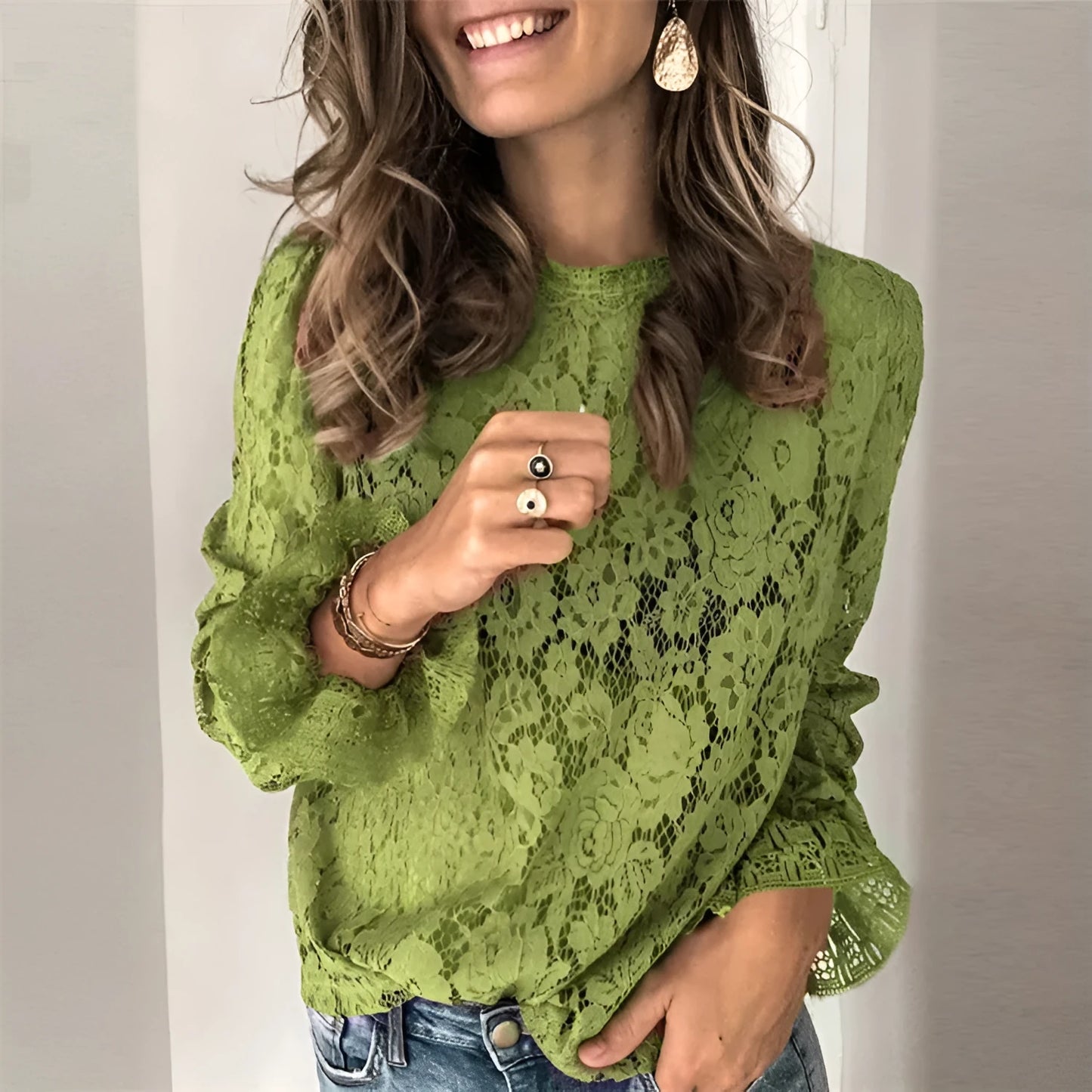 Women's loose fit hollow lace street shirt in green, showing round neck and long sleeves.