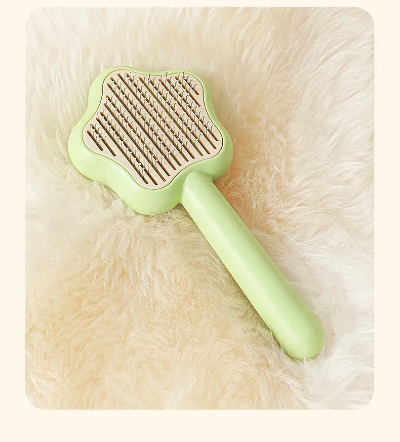 Green and yellow stainless steel self-cleaning cat comb for de-shedding, measuring 20cm.
