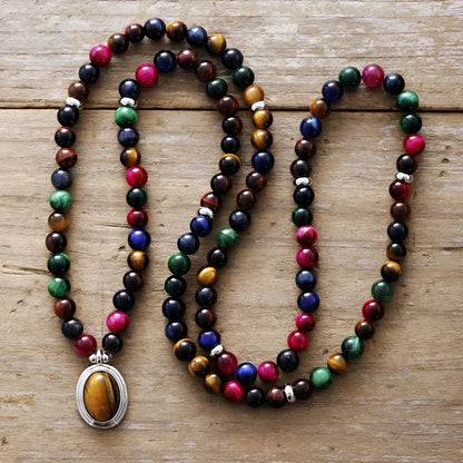 Coloured tiger-eye natural stone bead necklace and bracelet set with 108 gem-inlaid pendants on a dark background.