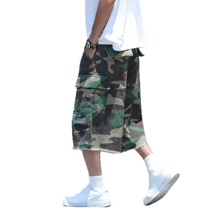 Man wearing loose-fit cropped camouflage shorts in a retro workwear style.