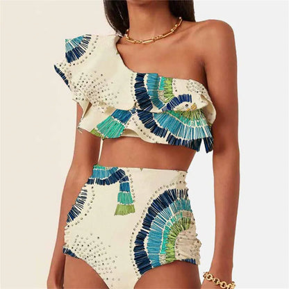 White women's one-shoulder swimsuit with draped lotus leaf design and high-leg split on a model