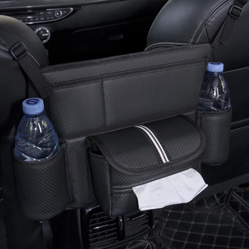 Black leather car seat gap storage bag hanging from armrest with tissue box, showing textured grain detail.