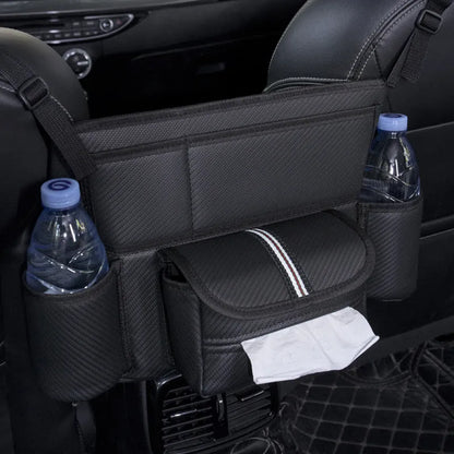 Black leather car seat gap storage bag hanging from armrest with tissue box, showing textured grain detail.
