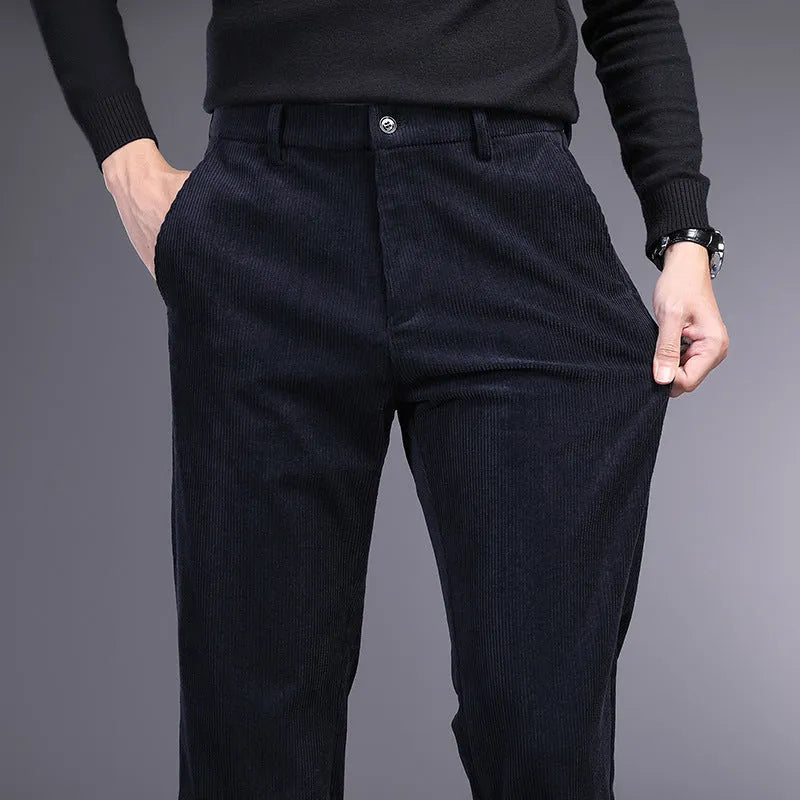 Man wearing khaki and black striped straight-leg retro trousers with a zip fly.