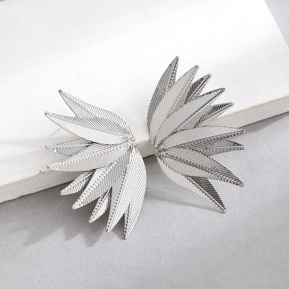 Gold and white alloy leaf-shaped patch earrings with botanical design