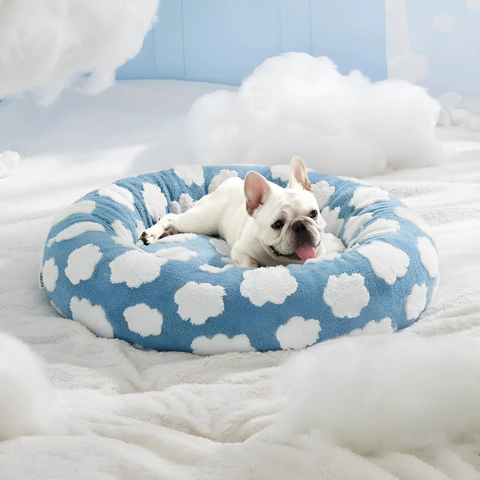 Round blue and white plaid dog bed with plastic sides on wooden floor