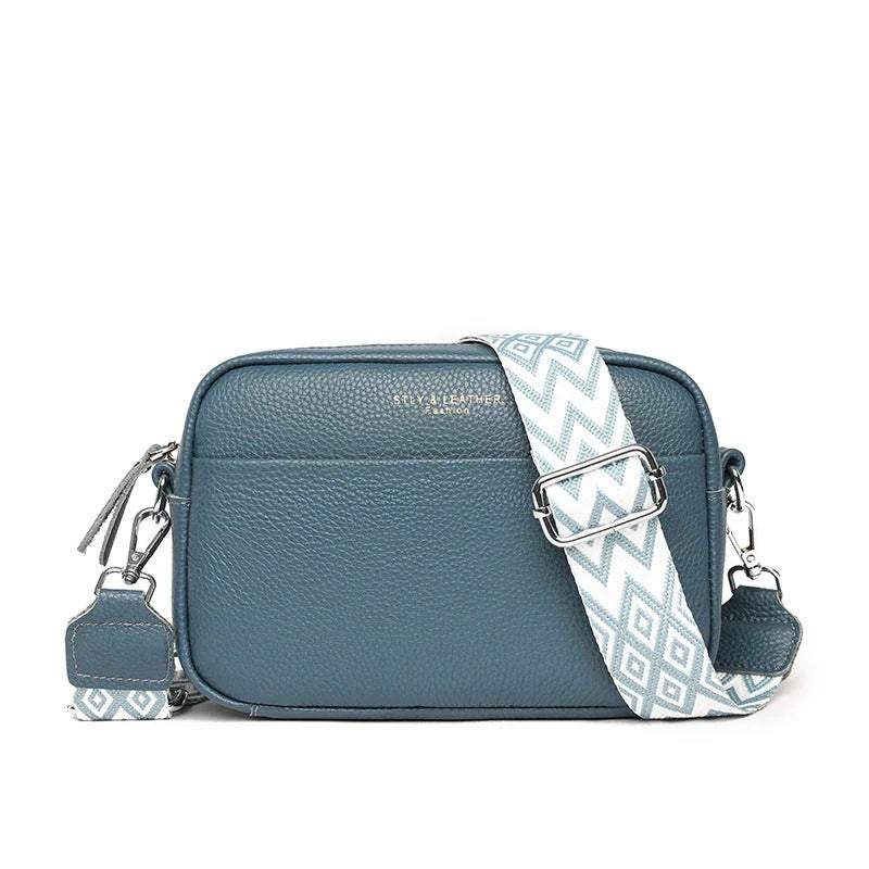 Stylish crossbody bag with rhombus embroidery, wide adjustable shoulder strap, and multiple interior pockets in various color options