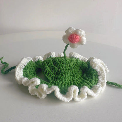 Green knitted cat hat with cartoon face on a kitten, showing S/M sizing for small pets.