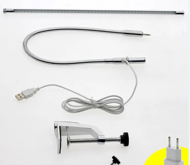 Silver aluminium alloy USB-powered LED nail table lamp with a long arm clip attached to a table edge.