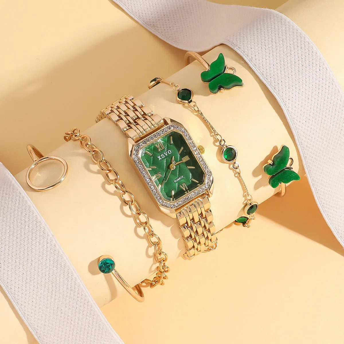 Gold green square women's watch with four matching butterfly bracelets on display