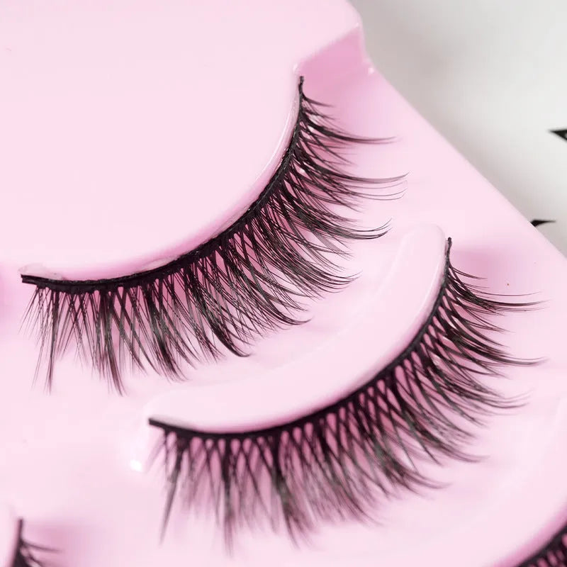 Three styles of black anime false eyelashes on a white background from a 15-pair pack.