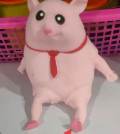 Adorable piggy-shaped stress relief toy made of eco-friendly rubber with a charming red scarf design