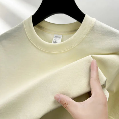 Men's thin cotton drop shoulder t-shirt on a hanger, shown in a light colour.