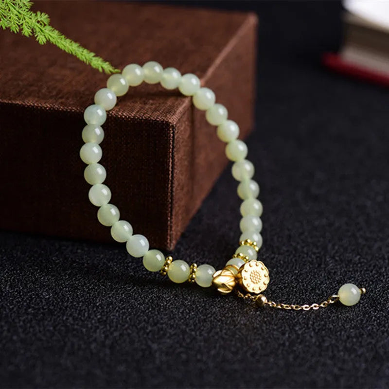 Natural Hetian jade bracelet with 6mm beads, engraved fu character, and constellation design on a simple string.