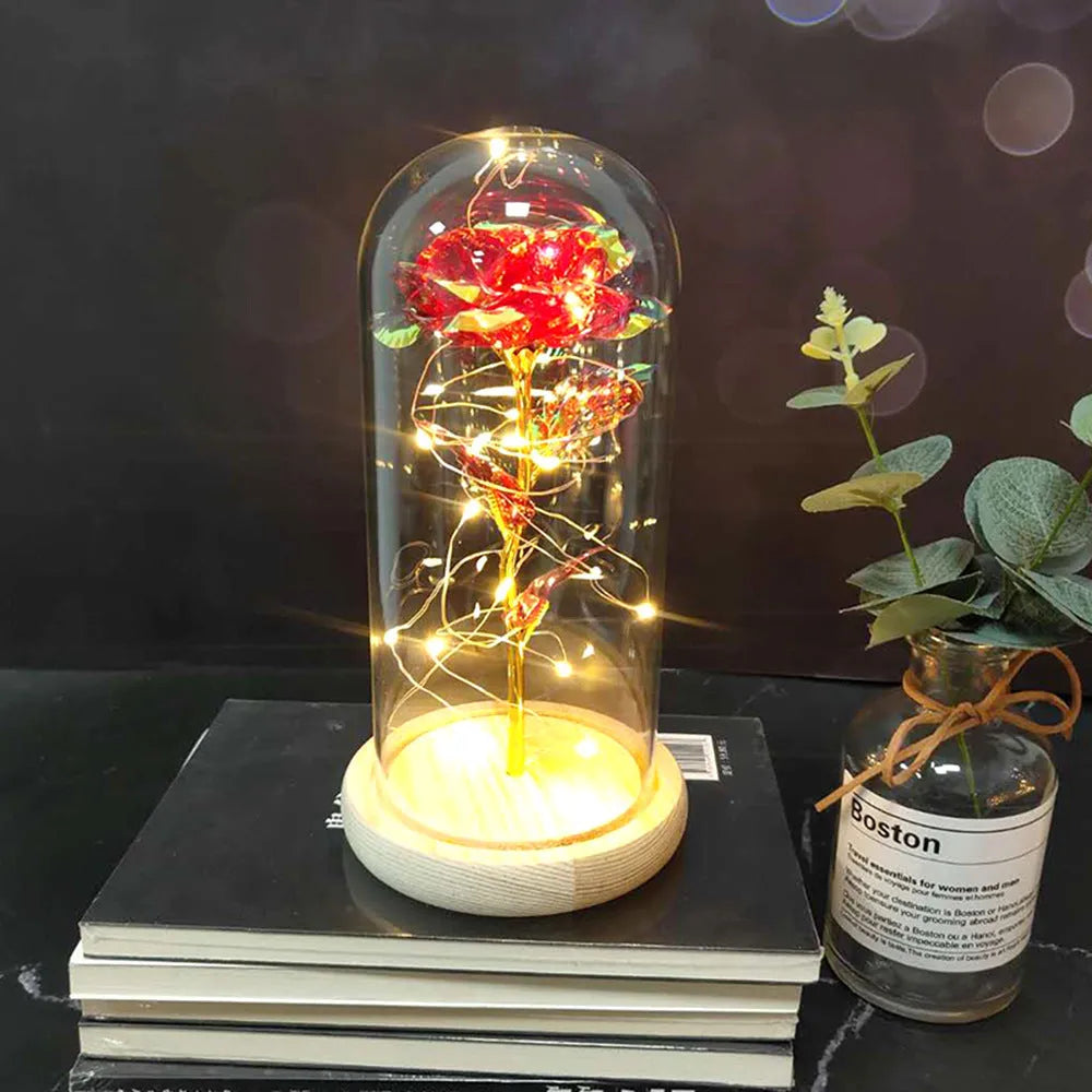 LED simulation rose ornament with glass lampshade on a solid wood base, showing a choice of rose colours.