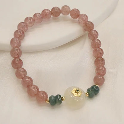 Women's bracelet with strawberry quartz stones and blue water emerald round jade pendant featuring peace buckle closure
