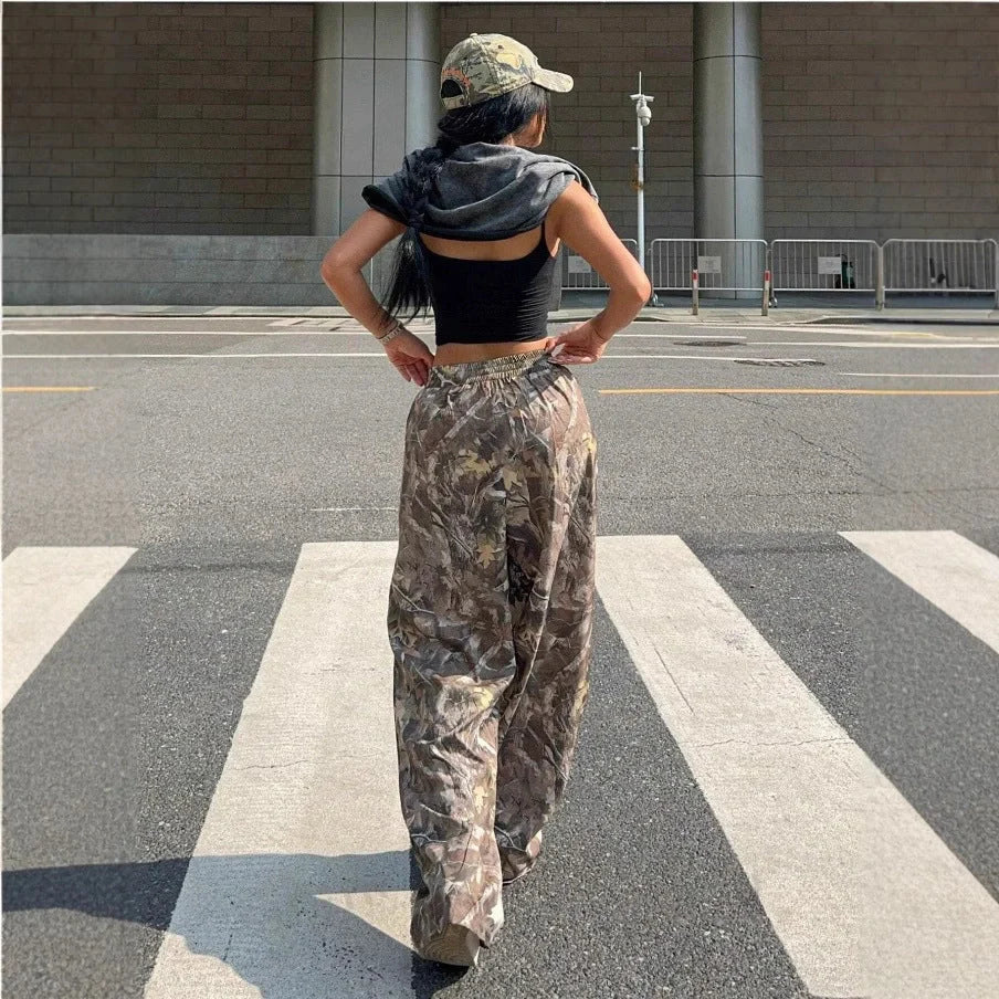 Stylish women's camouflage cargo pants with multiple pockets for a trendy look.