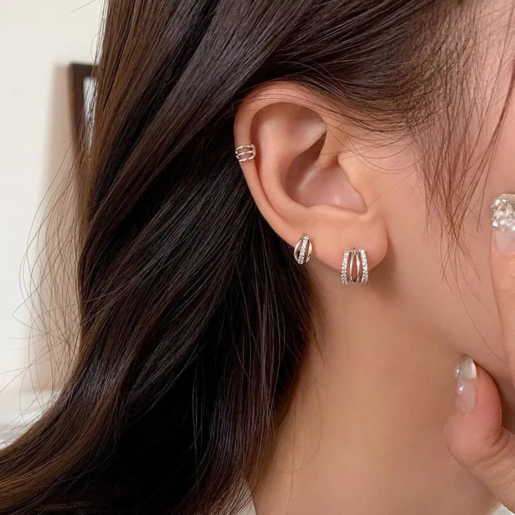 Pair of modern geometric stud earrings with a silver electroplated finish on a 925 silver post.