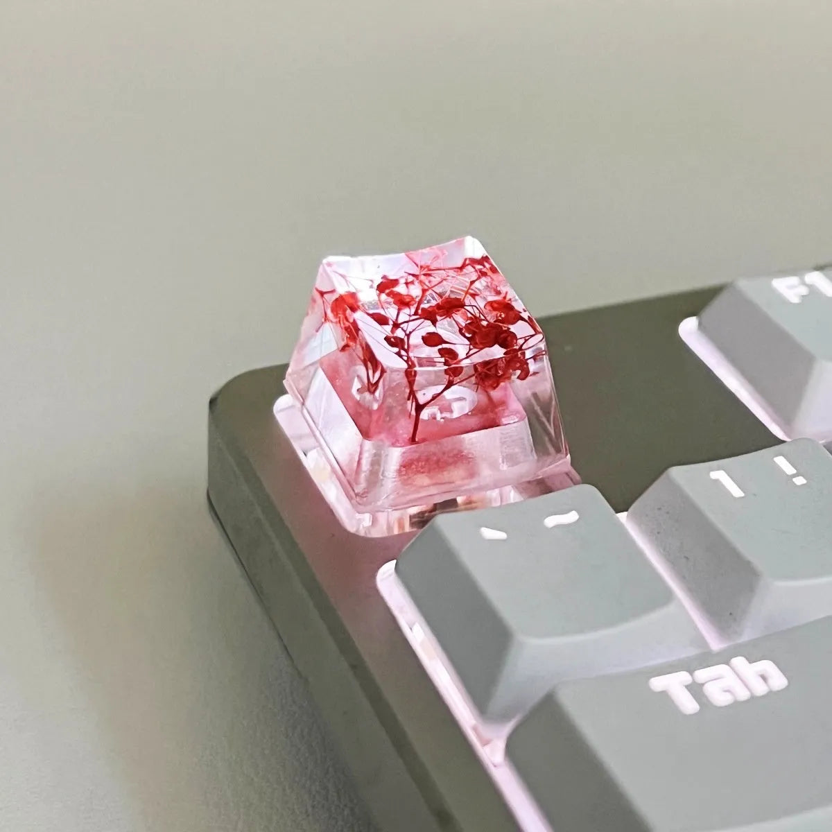 Transparent resin mechanical keyboard keycap with glitter starry sky effect in red, pink, green, or violet.