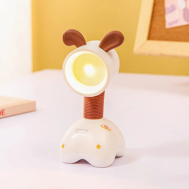 Colourful cartoon character magnetic DIY night light on a desk with adjustable head.