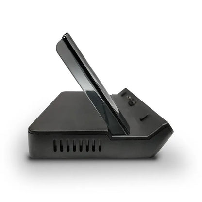 GPD WIN4 handheld game console sitting in a black docking base expander showing multiple ports on the front.