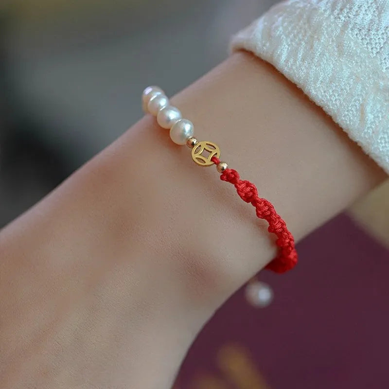 Women's pearl bracelet with braided red rope and geometric fu character charm