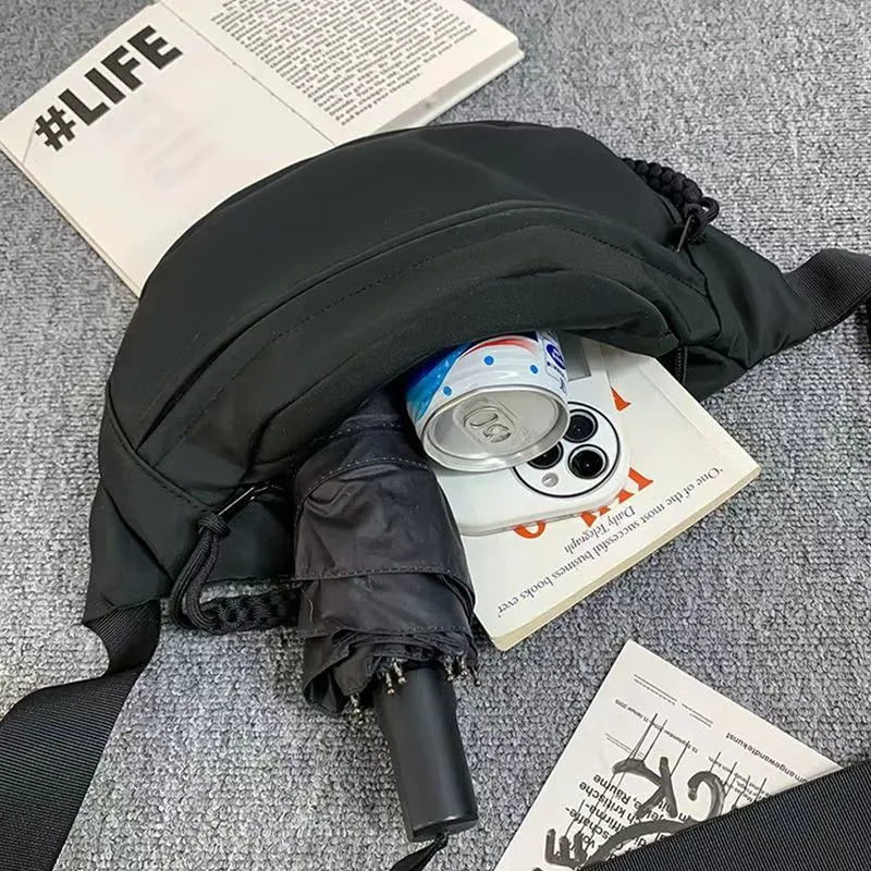 Men's small black polyester crossbody chest bag with adjustable strap.