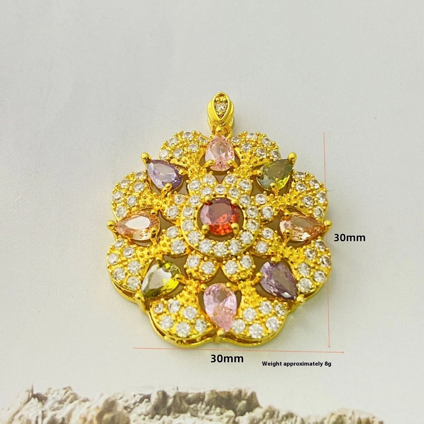 Close-up of a women's flower-shaped pendant necklace with a colourful zircon stone in a choice of gold, champagne gold, or platinum colour finishes.