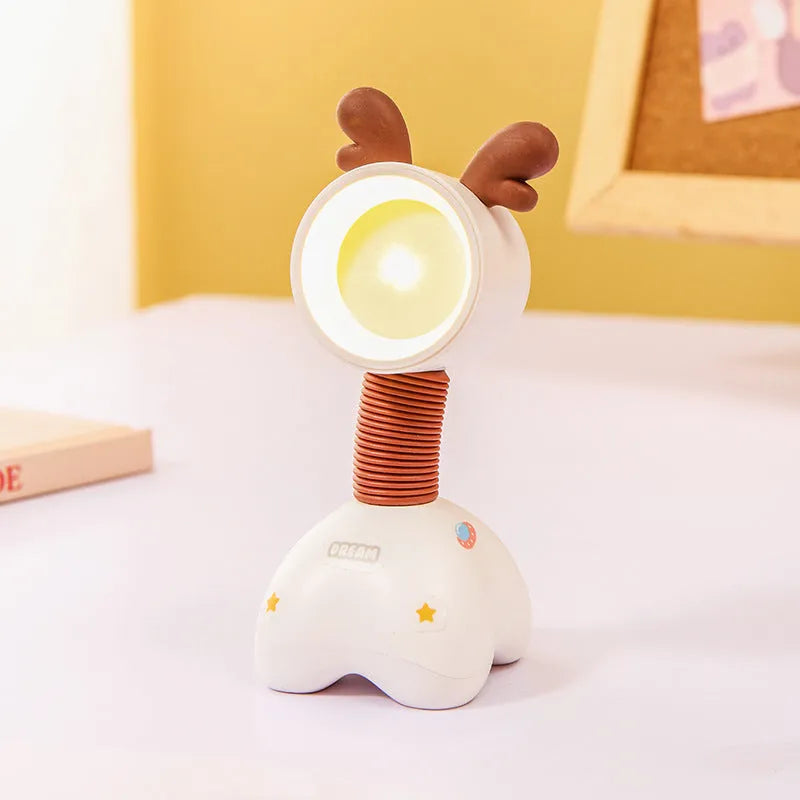 Colourful cartoon character magnetic DIY night light on a desk with adjustable head.