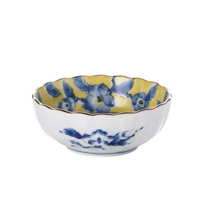 Yellow ceramic tableware set with colourful floral patterns, includes bowls and plates in Japanese style