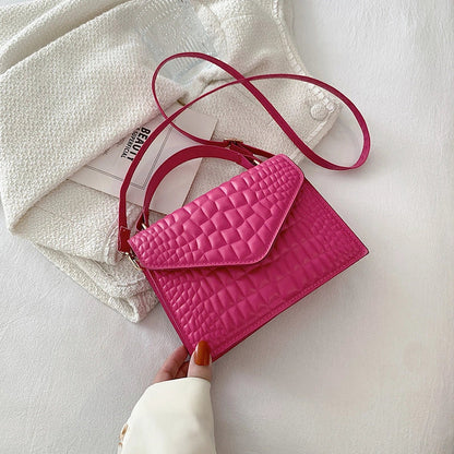 Clamshell handbag with crocodile pattern and soft handle in various colours