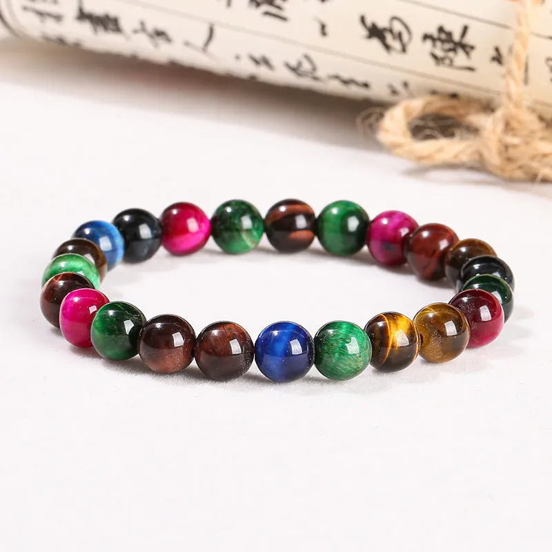 A unisex colourful Tigereye stone bracelet with round beads on a lace string, showing different bead size options.
