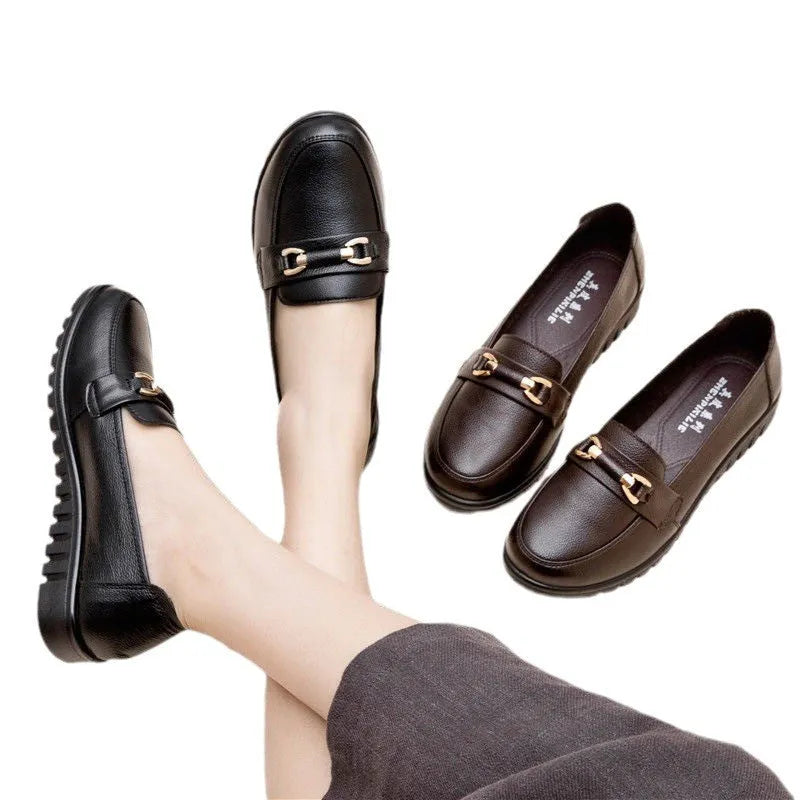 Black casual pumps with round toe, low flat heel, soft bottom, and a subtle metal detail on the upper.