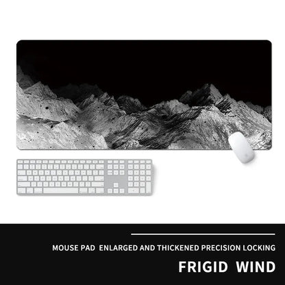 Oversized rectangular mouse pad with a printed design on a desk, next to a keyboard and mouse.