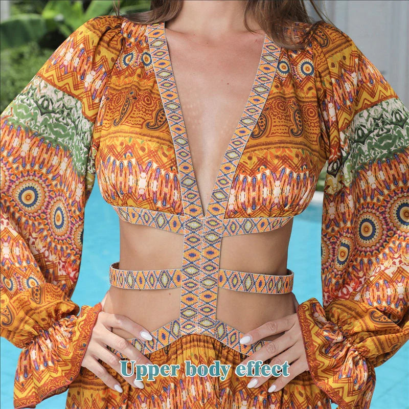 Elegant floral print dress with long sleeves and empire waistline in vibrant orange color