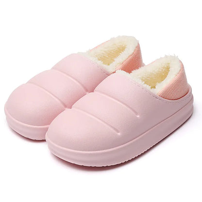 Pair of yellow waterproof EVA slippers with plush lining and a textured non-slip sole on a wooden floor.