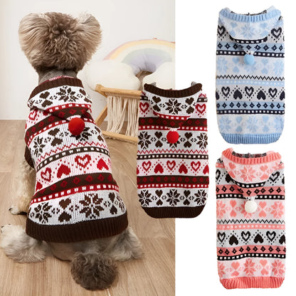 Small dog wearing a pink camouflage patterned knitted sweater with snowflake and heart stripes.
