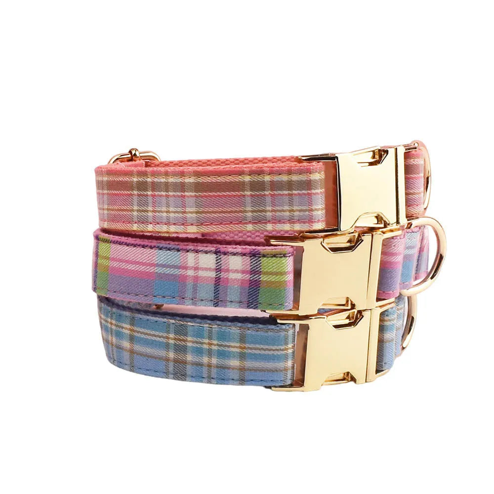 Red plaid cloth dog collar and leash set with matching bow on a white background