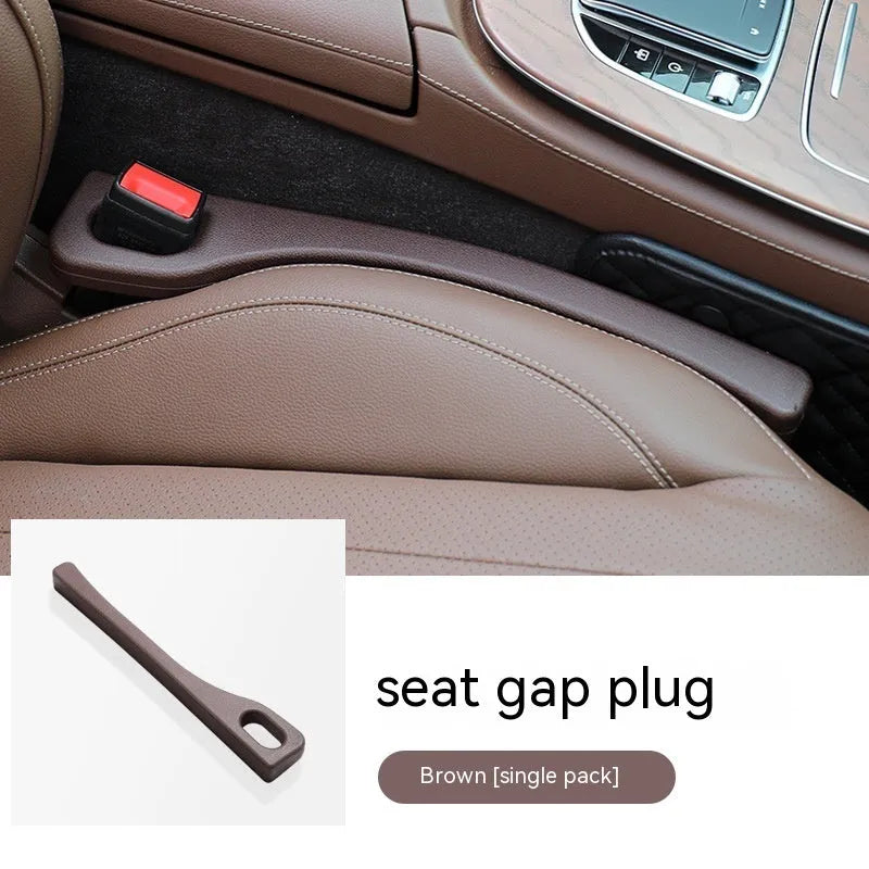 Polyurethane car seat gap filler strip in assorted colours on a car seat.
