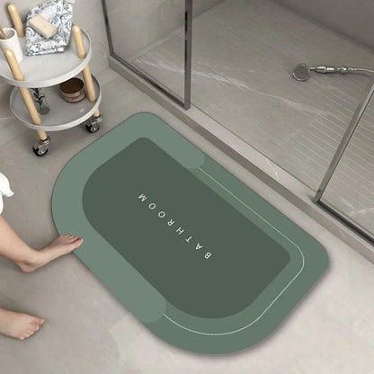 Oval diatomite bathroom floor mat in blue with natural rubber non-slip backing on tiled floor.