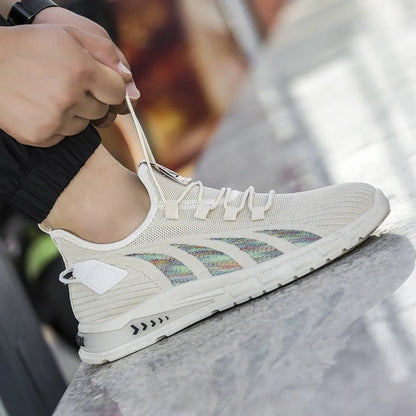 Low-top casual sneakers with striped mesh upper and flat plastic sole in grey colour.