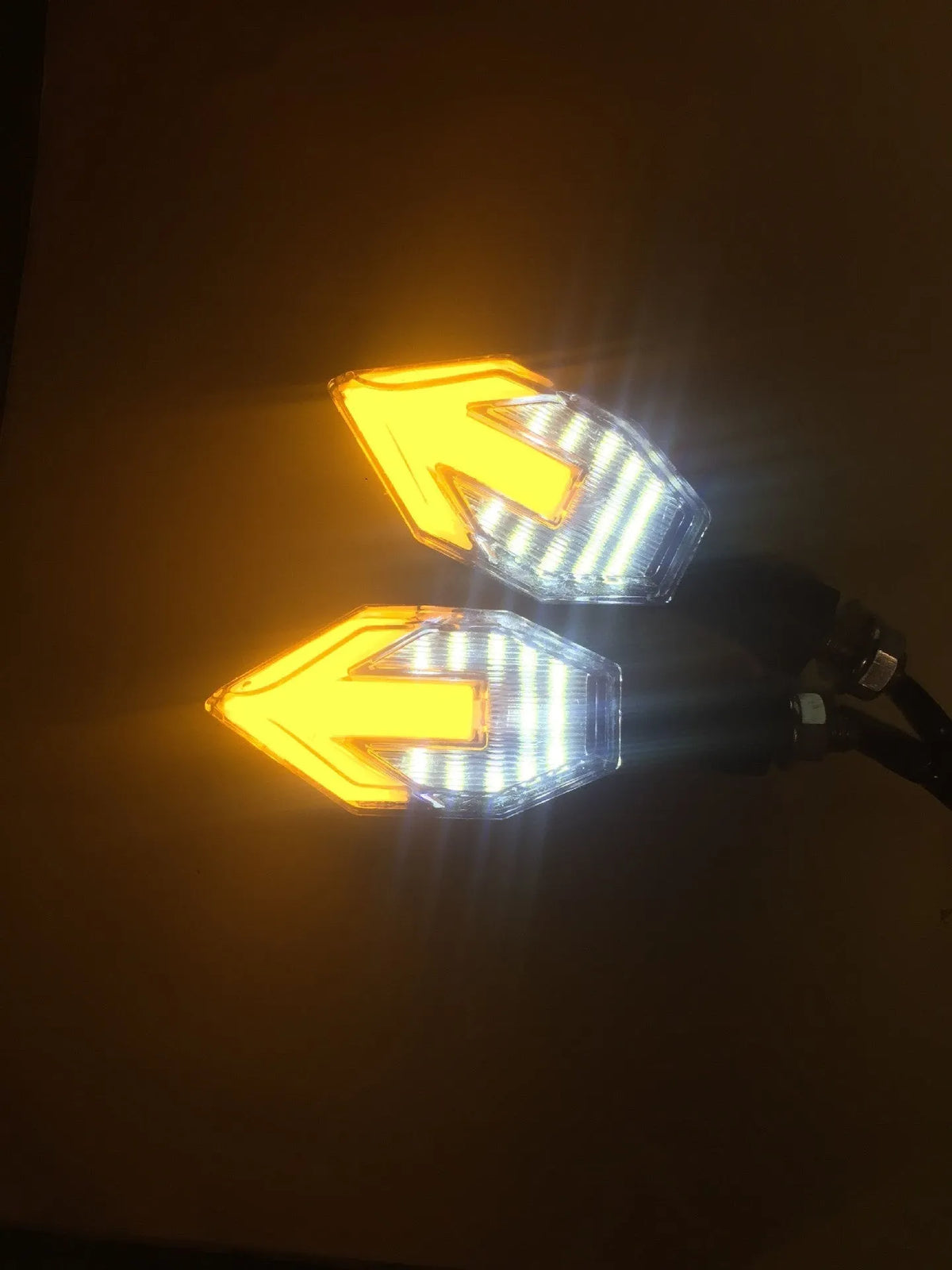 Arrow-shaped LED motorcycle directional turn signal light for 12V systems.