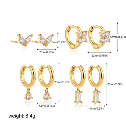Set of four pairs of geometric copper earrings with zircon stones in gold or silver electroplated finish.