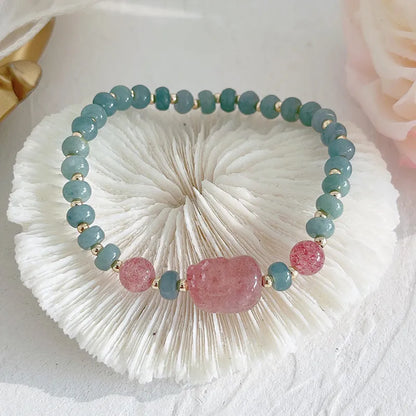 Simple blue jade bracelet with gourd charm, peace buckle, and adjustable cord on woman's wrist