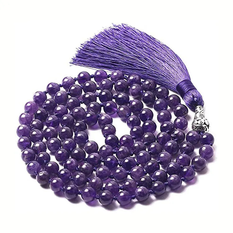 Long multi-coloured agate and stone tassel necklace with geometric beads on a white background.