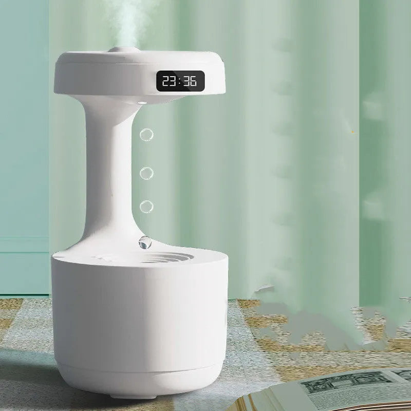 White columnar anti-gravity humidifier with water droplet backflow and LED clock display on a desk.