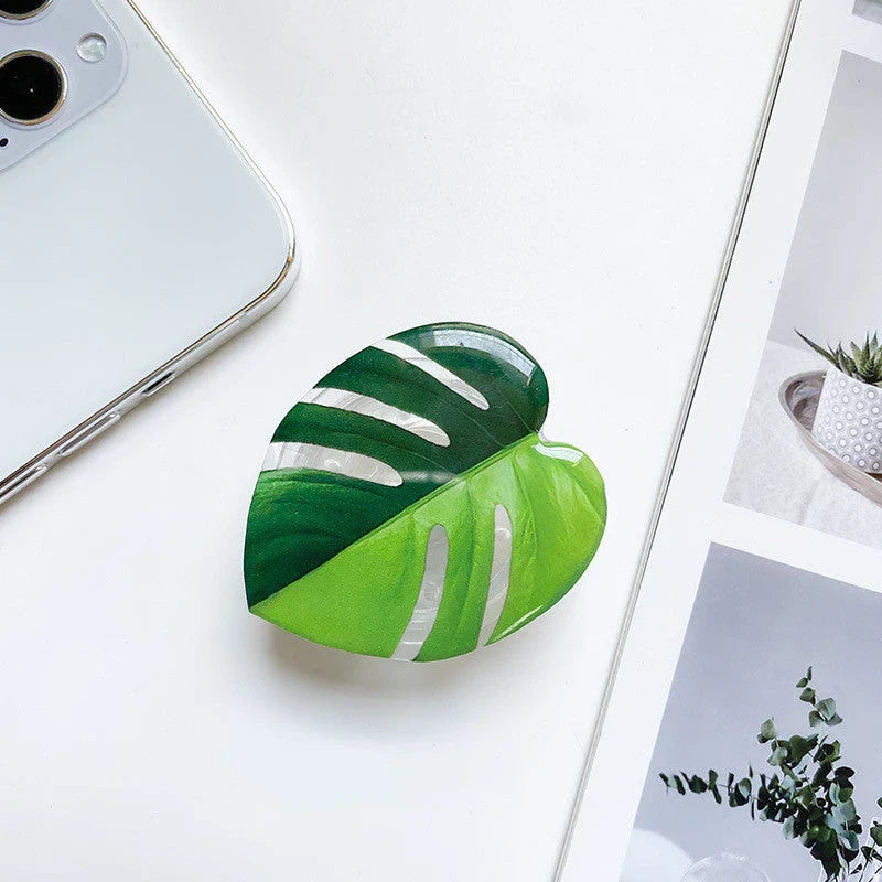 Stylish smartphone stand with leaf-inspired design for secure hands-free support and mobile device versatility